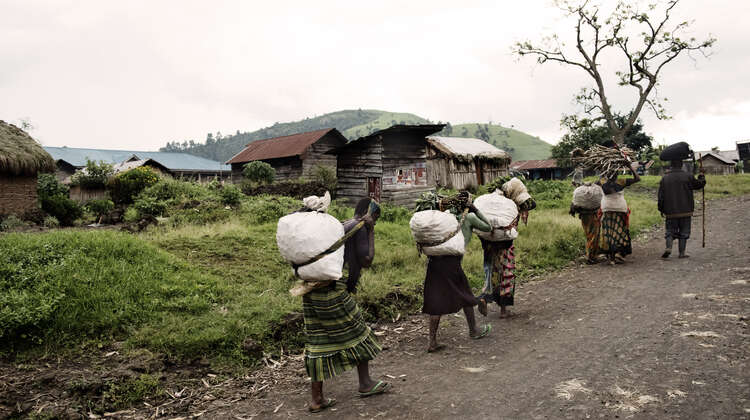 Women carrying big bags.