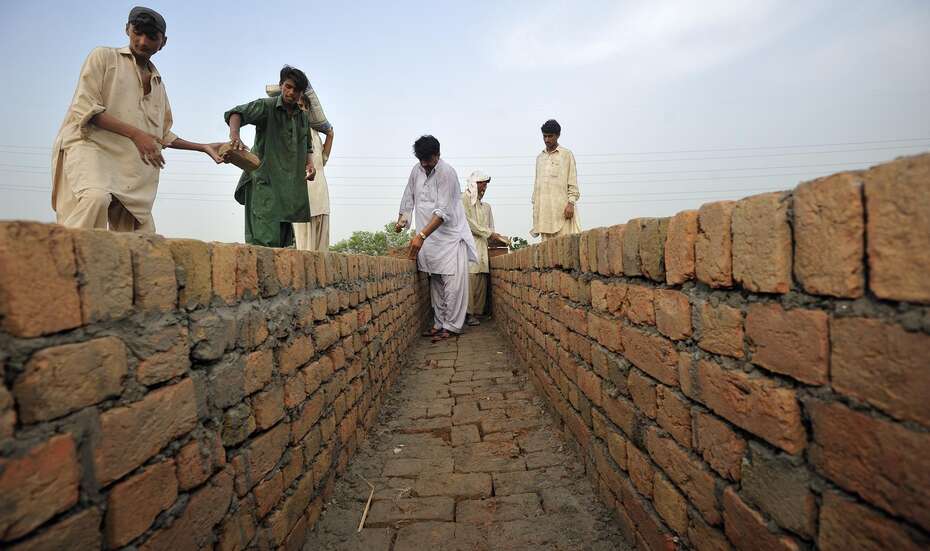 Männer arbeiten an einem Kanal