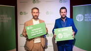 Daniel Boschmann und Matthias Killing halten Schild der Welthungerhilfe in die Kamera.
