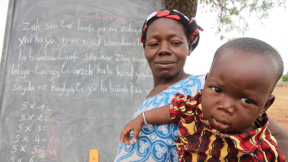 Mutter mit Baby bei Alphabetisierungskurs in Burkina Faso