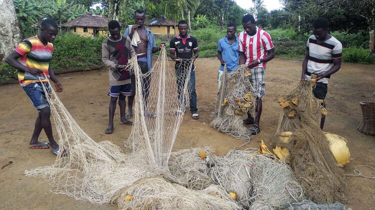2019-fischer-liberia-netze-C_Chelleh-Mitchell-16-9.jpg Eine Gruppe von Männern beim Sortieren von Fischernetzen