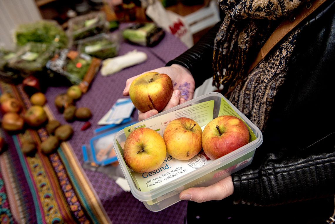 Eine Frischhaltebox mit drei Äpfeln