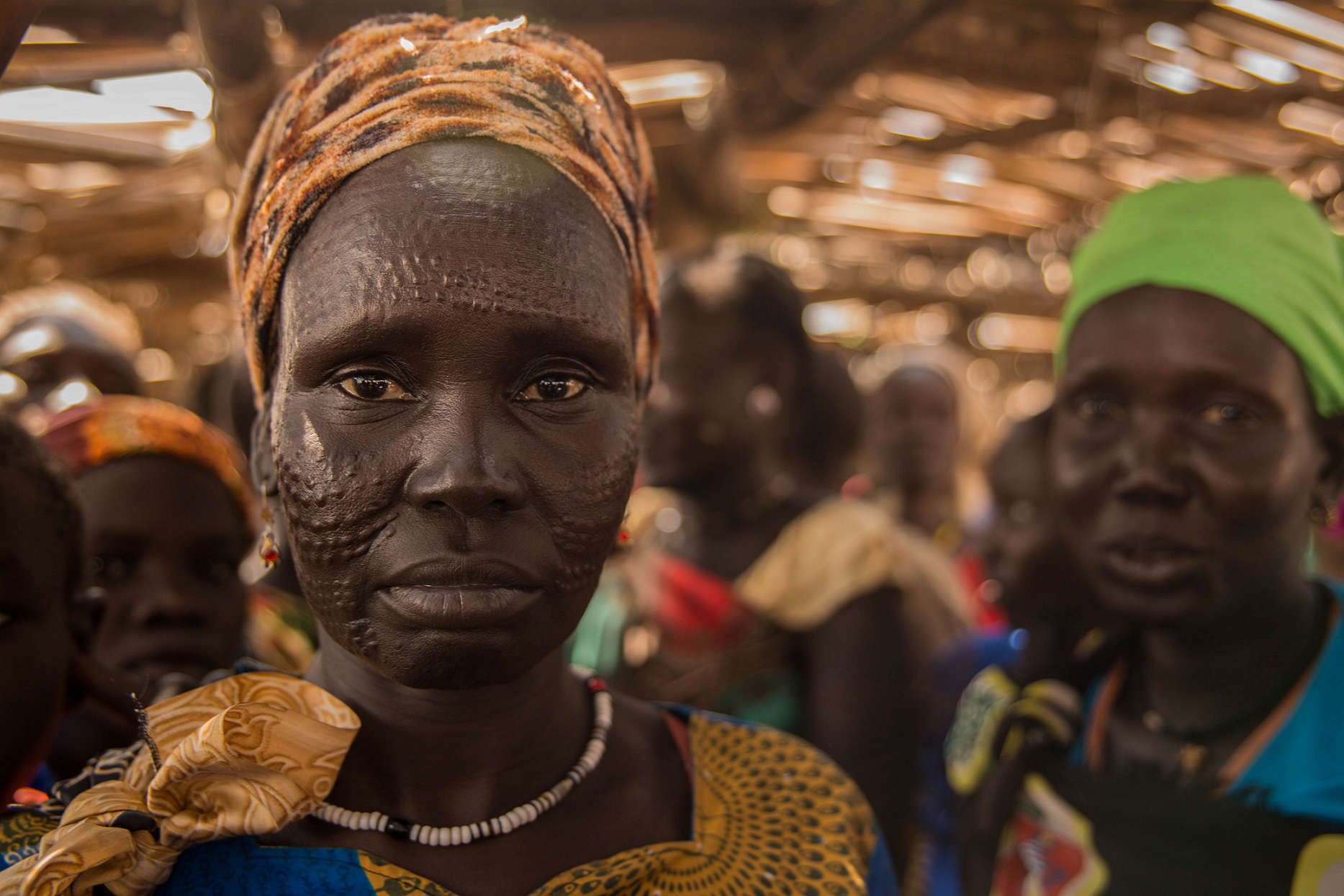 Eine südsudanesische Frau schaut im Porträt direkt in die Kamera.
