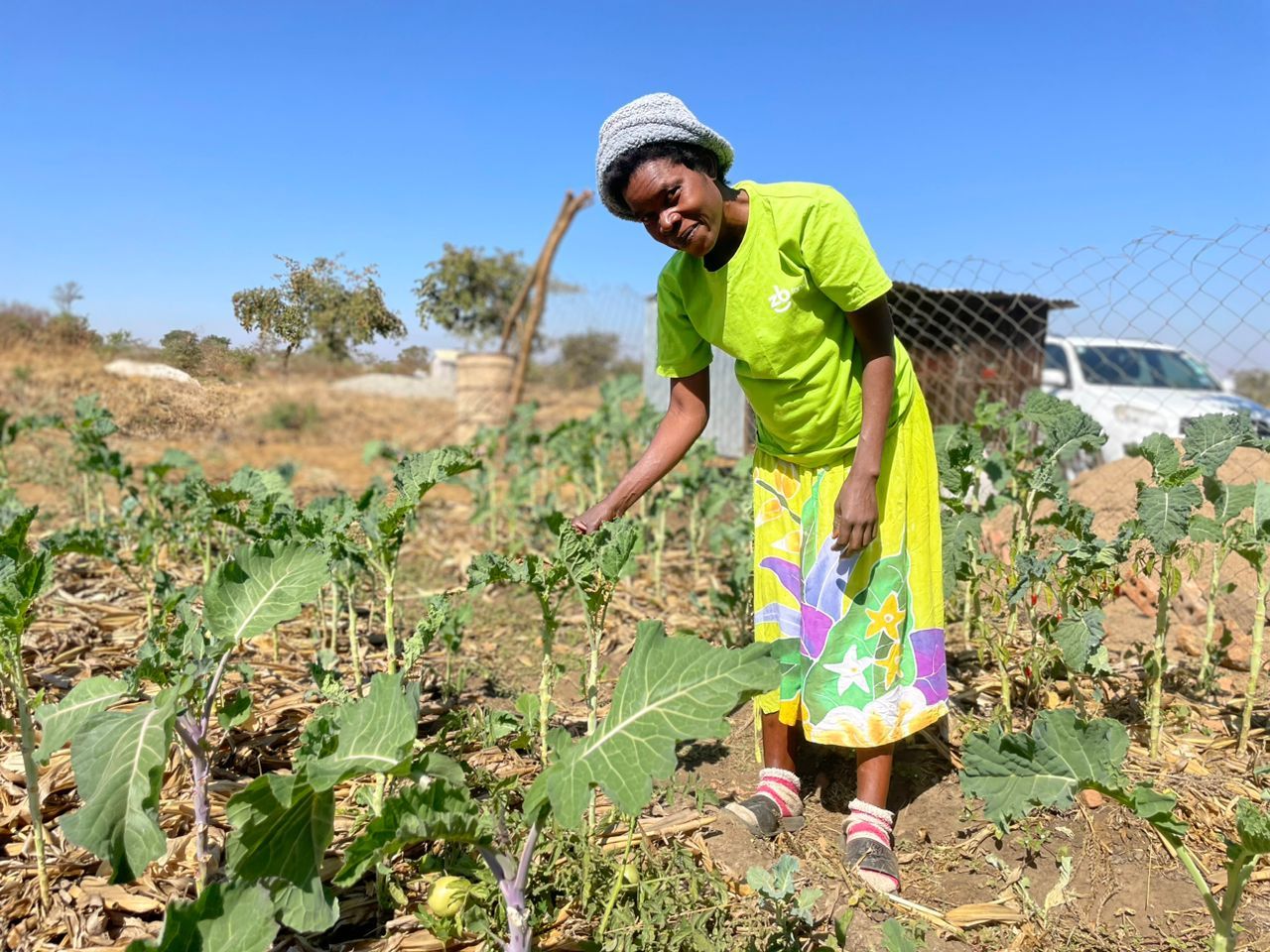 Eine Frau steht in einem Gemüsebeet.