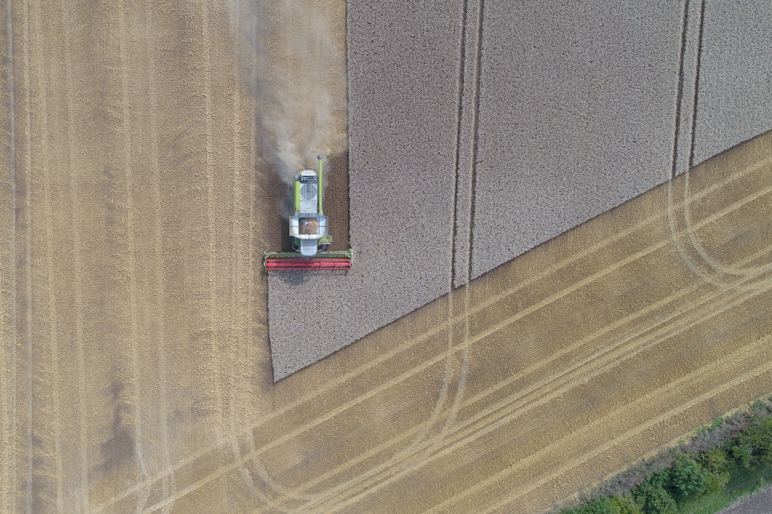 Ein Mähdrescher auf einem Feld aus der Vogelperspektive.
