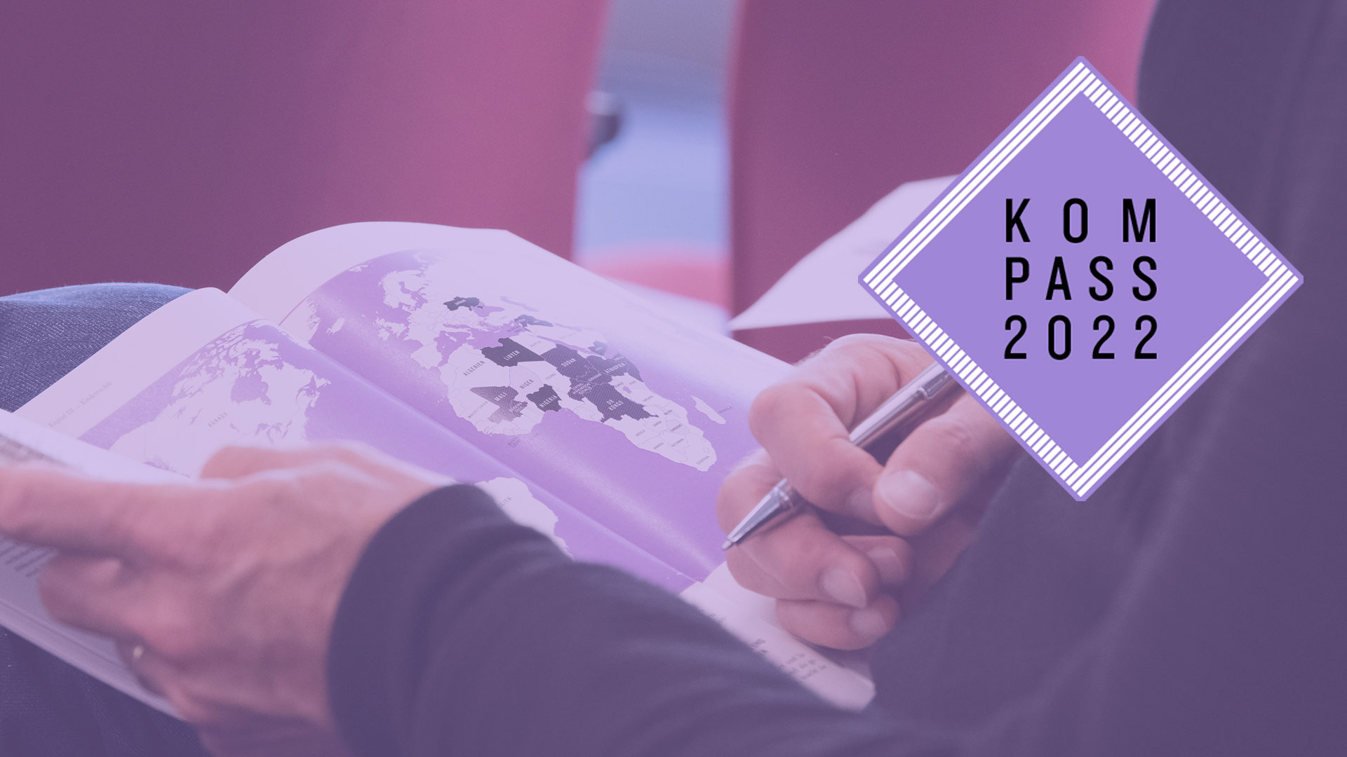 2022-kompass-pk-weltkarte_C_steinkopf.jpg Bei der Pressekonferenz zum Kompass 2022 in Berlin – eine Person hält die Druckausgabe des Kompass 2022 in den Händen, aufgeschlagen ist eine Weltkarte.